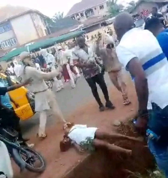 Outrage as masquerades brutally flog female nurse until she falls in a gutter in Enugu (video)