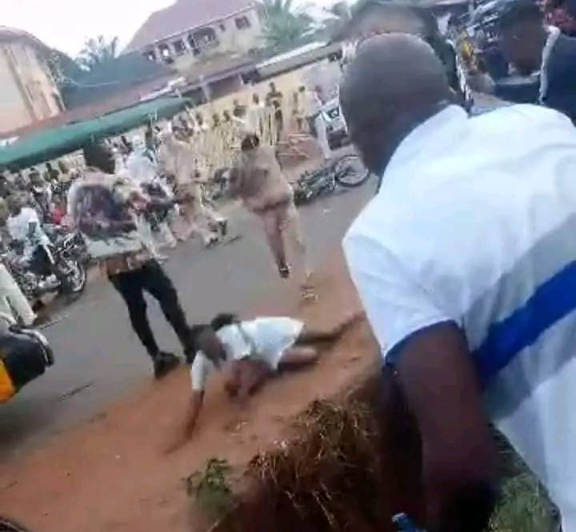 Outrage as masquerades brutally flog female nurse until she falls in a gutter in Enugu (video)