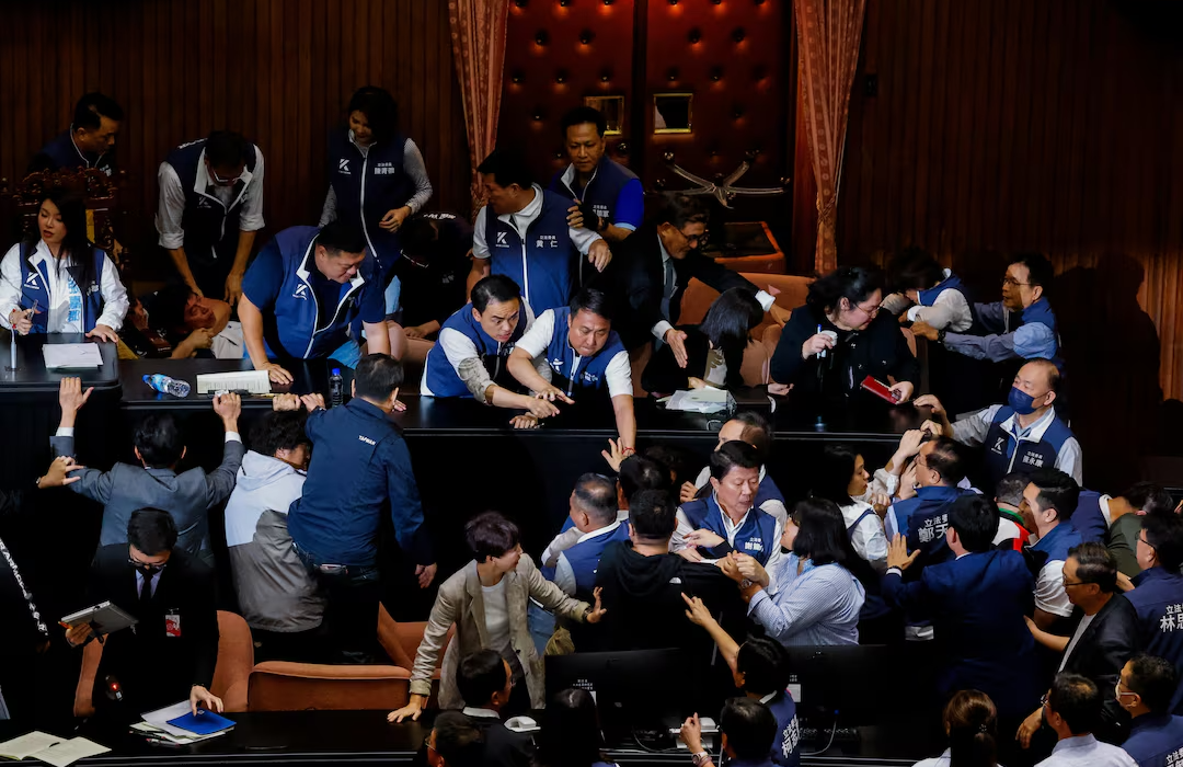 Taiwan lawmakers tackle each other and exchange blows in bitter dispute over parliament reforms (video)